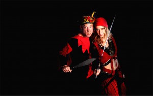Mittelalterliches Gauklerpaar in rot schwarzen Kostümen mit Messer und Säbel